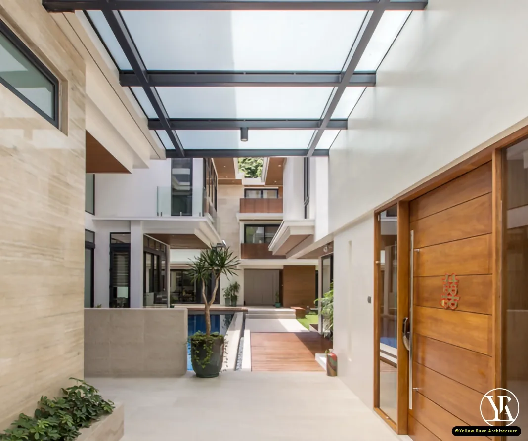 Coastal Courtyard Residence — street elevation at dusk showing white render facade, horizontal timber slats and louvred aluminium gate