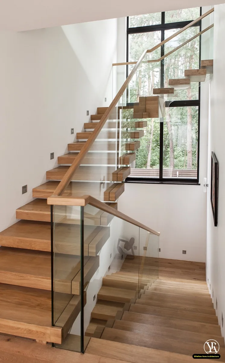 Alone With Nature — close-up of floating oak staircase with open treads and pine forest view through full-height window