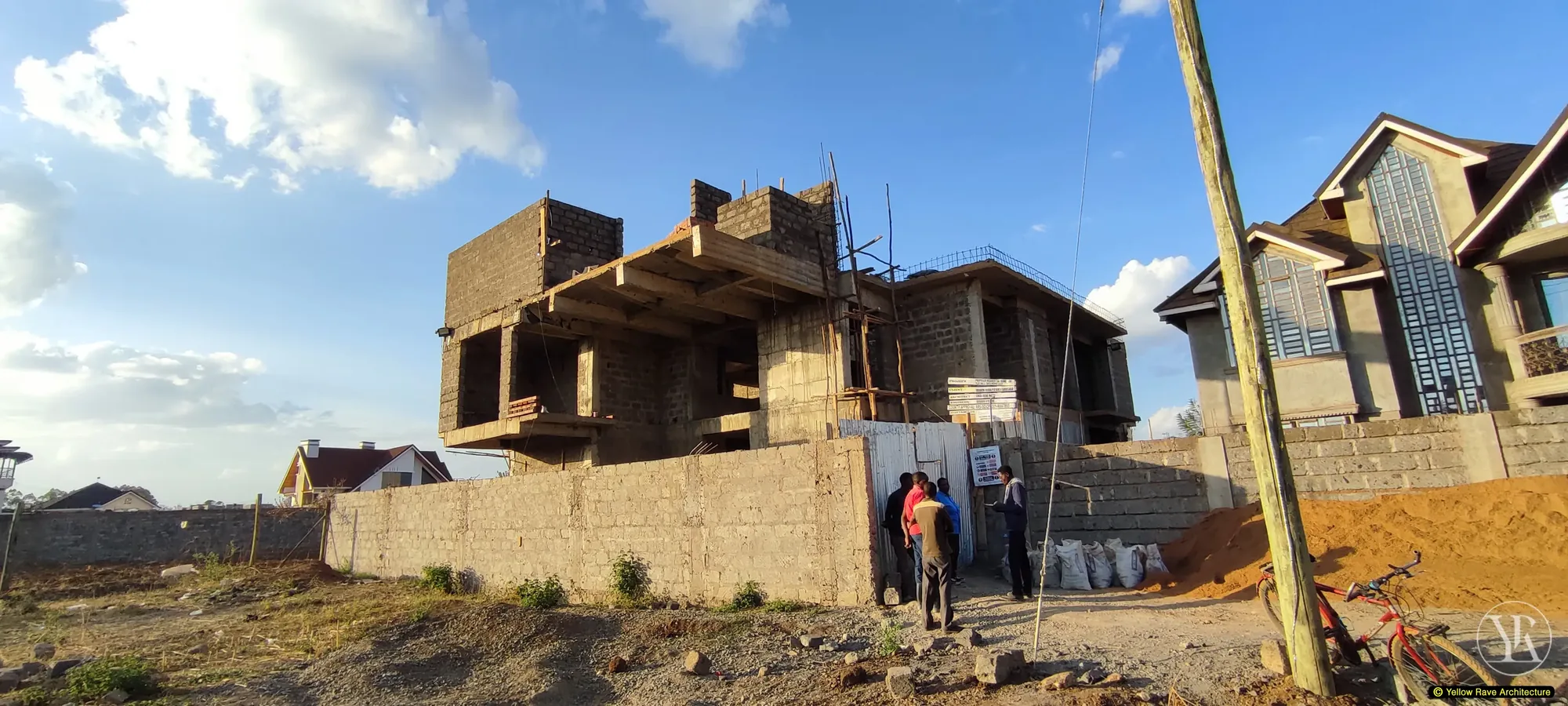 Cantilever House — mid-construction view with scaffolding and concrete block work in progress