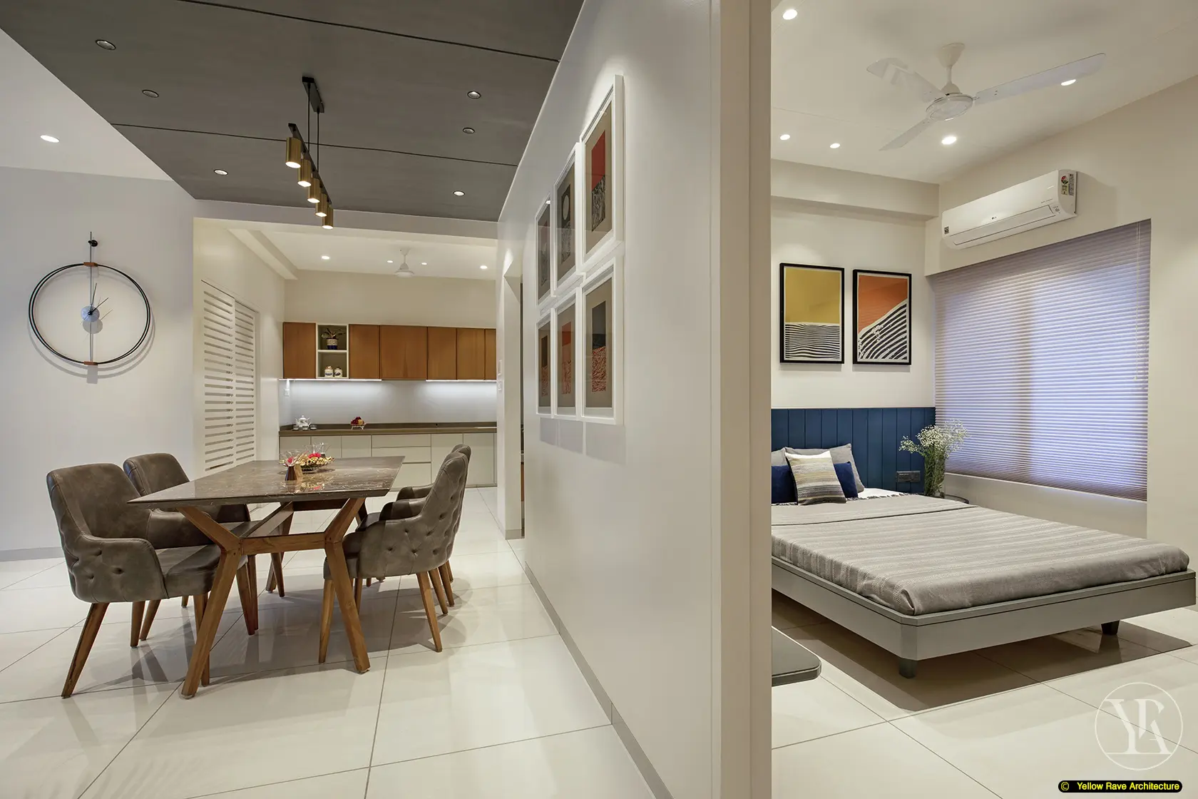 Nyali Apartment — entry zone with zig-zag cut base of timber batten wall transitioning to grey stone console unit with round gold-framed mirror above