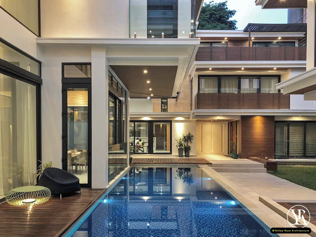 Coastal Courtyard Residence — interior living room with marble floor, timber staircase, white sofa and open view to the pool terrace