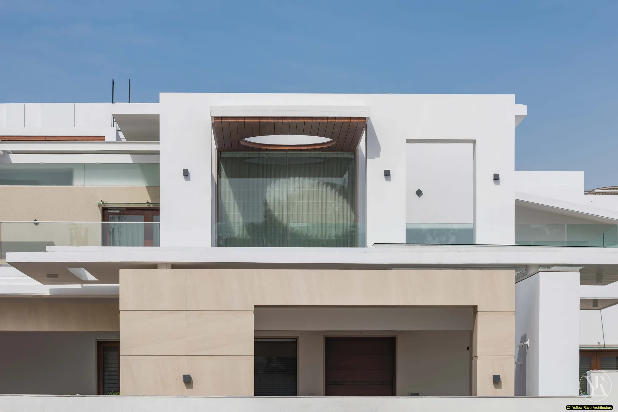 Nyali Residence — upper balcony terrace with terracotta square tiles, glass balustrade and curved white parapet framing a view of the sky