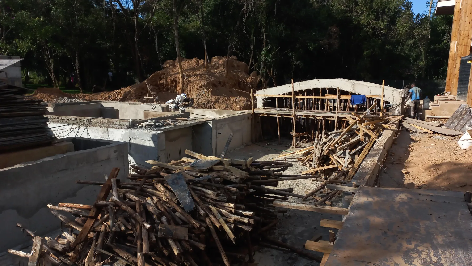 House of Wood and Marble — construction progress showing stone and timber elements at a late stage, Karen, Nairobi