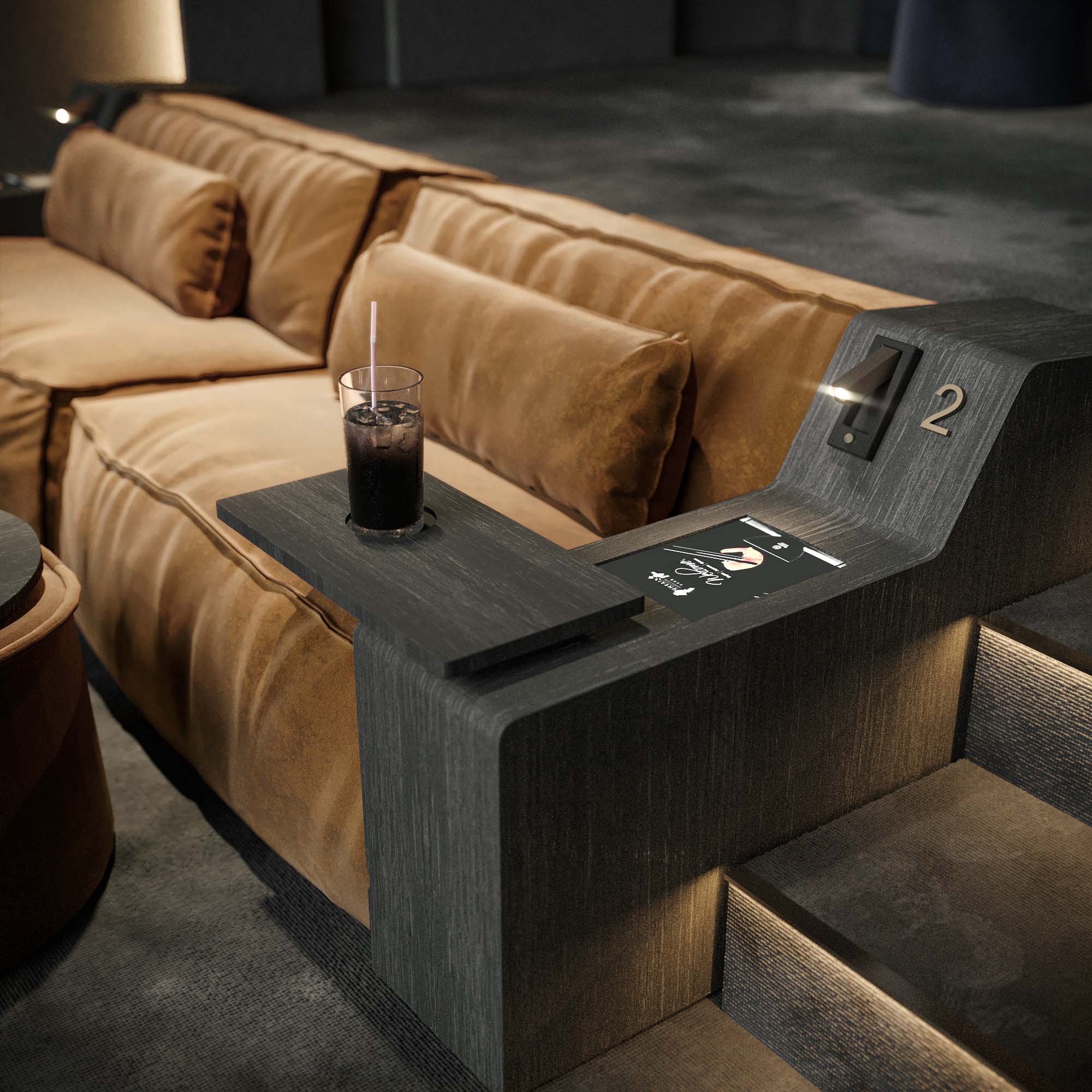 Cinema — main auditorium from the front showing the projection screen, curved grey acoustic wall treatment and tiered recliner seating