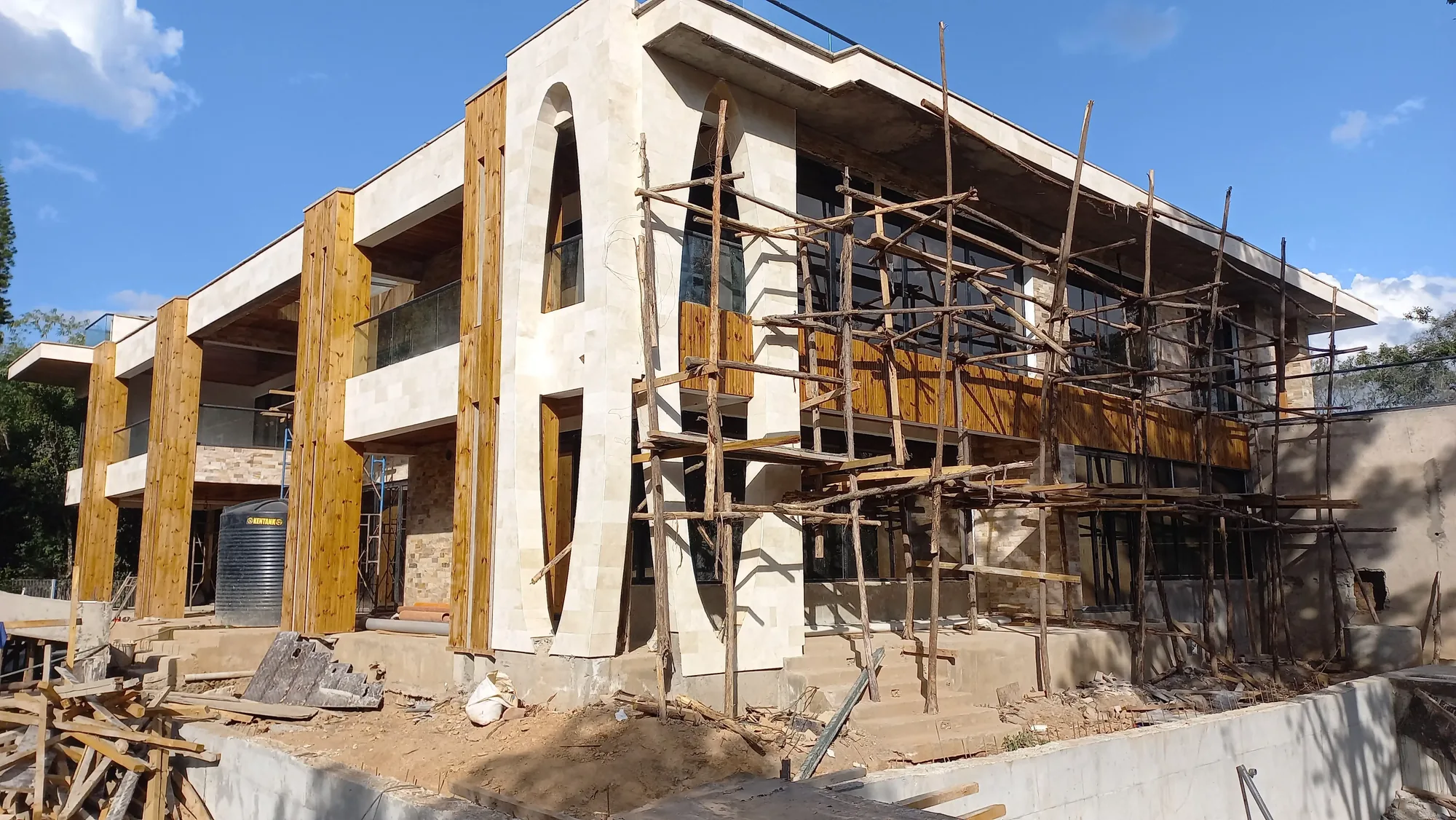 House of Wood and Marble — construction detail showing stone material quality and coursing work by site crew