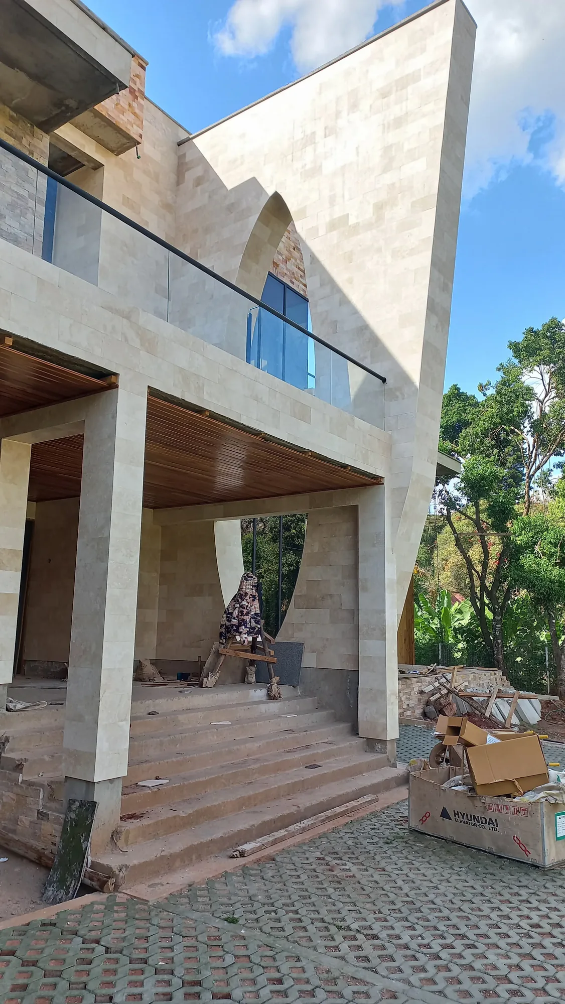 House of Wood and Marble — cedar timber soffit boards being installed with large skylight opening framed in steel