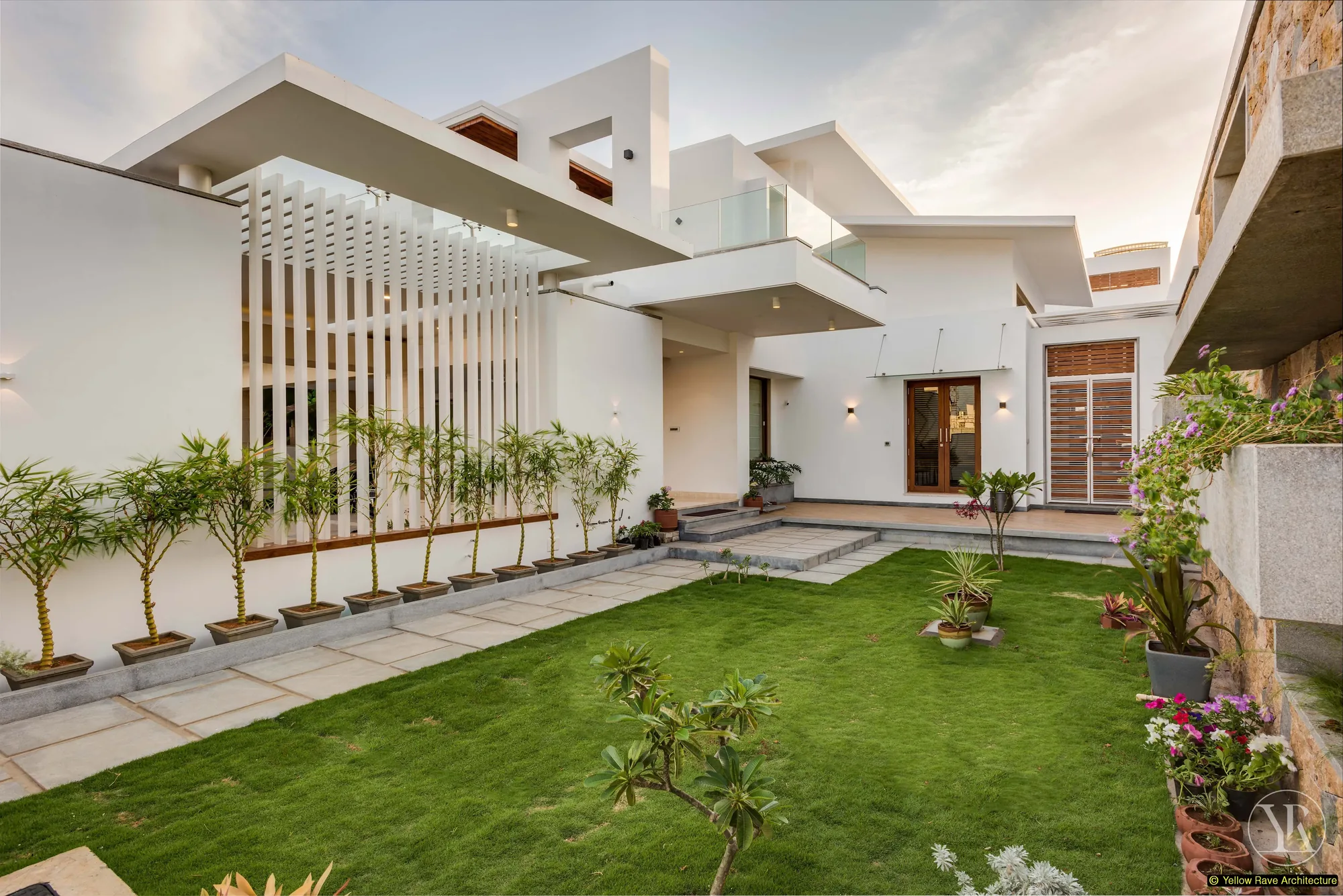 Nyali Residence — detail of white louvred pergola structure with horizontal slats and vertical steel framing against blue sky