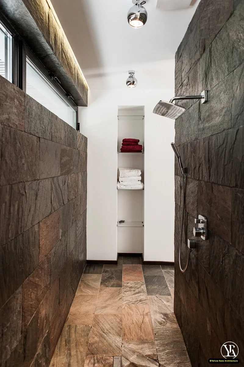 Alone With Nature — kitchen with brown flat-front cabinetry, white island and black globe pendant track lighting