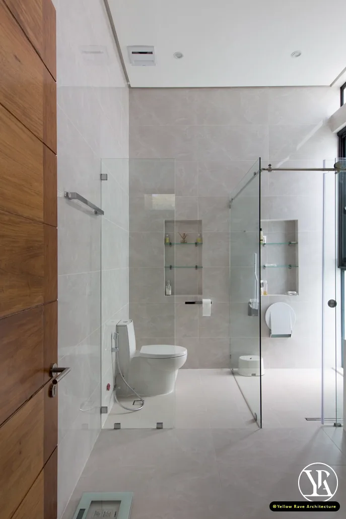 Coastal Courtyard Residence — grey large-format tiled bathroom with frameless glass shower and built-in shelf niches