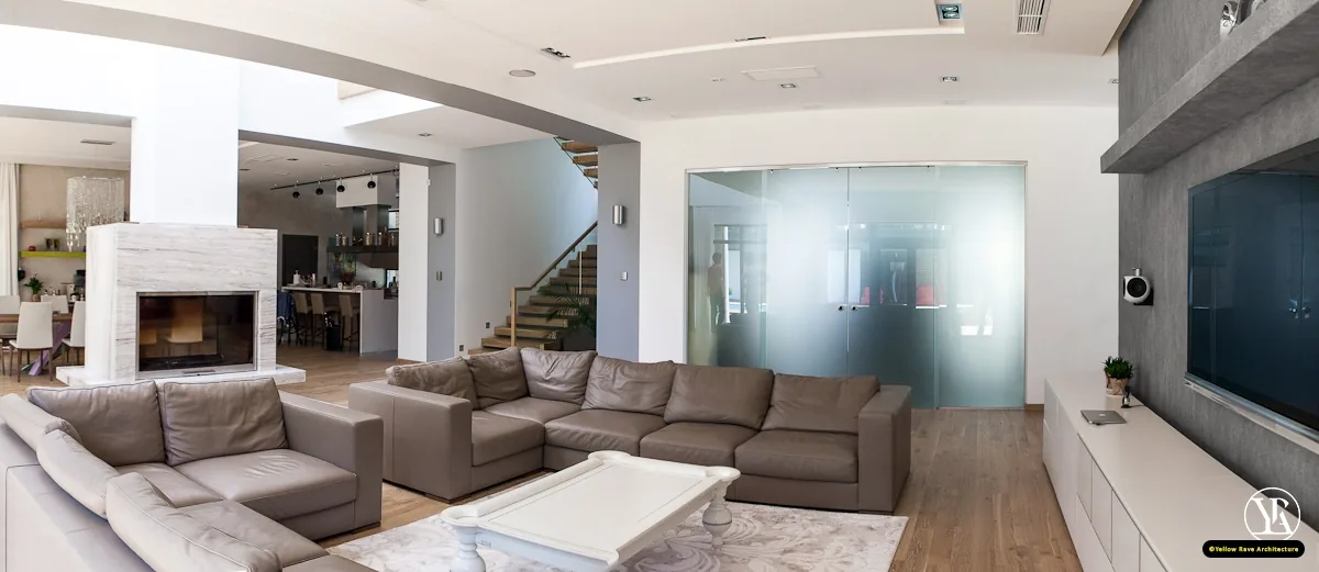 Alone With Nature — open-plan living area with grey sectional sofa, marble fireplace and floating staircase, Milimani, Nakuru