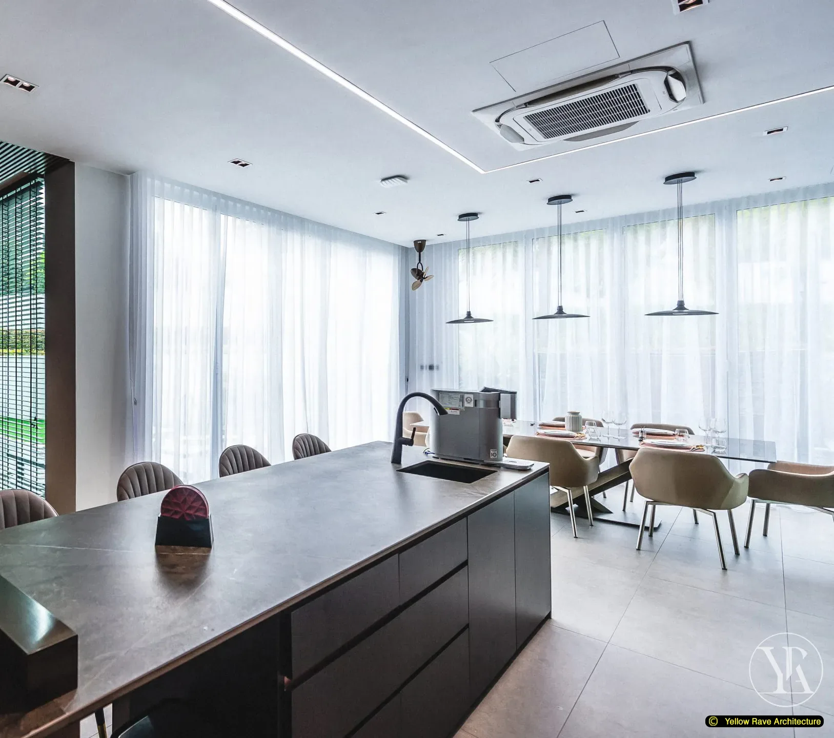 Soft Mirrored Kitchen — formal dining zone with eight tan bucket chairs around a large dining table, three dark pendant lights above and full-height glazing with sheer drapery beyond