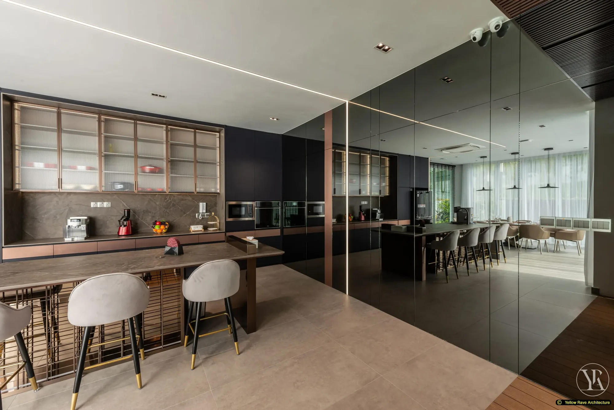 Soft Mirrored Kitchen — wide kitchen view showing full run of navy cabinets, smoky mirror panel, breakfast bar and grey velvet bar stools in foreground