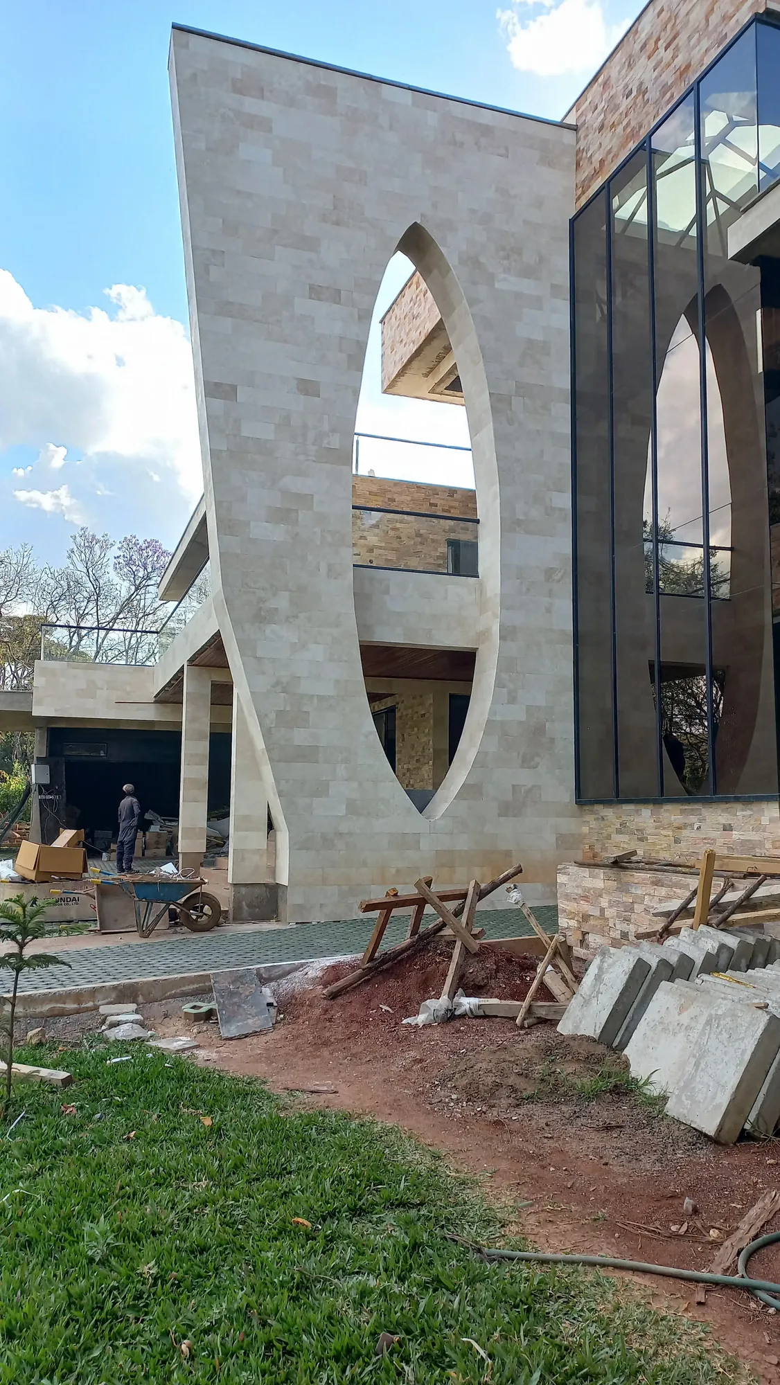 House of Wood and Marble — aerial site view of pool structure under construction showing RC concrete pool shells and terrace formwork