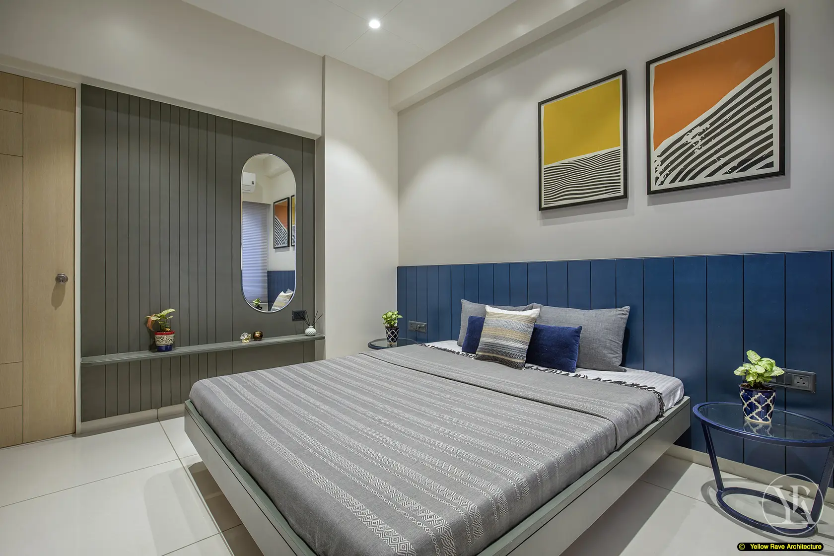 Nyali Apartment — second bedroom with warm timber panel wall, grid of ten botanical art prints, and bed with floral bedspread