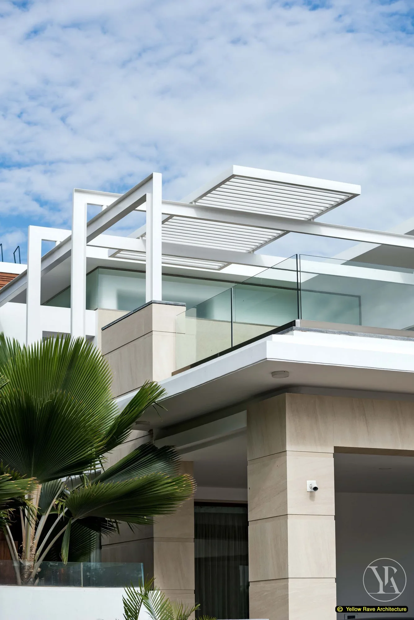 Nyali Residence — upper-floor exterior showing central recessed balcony with timber soffit and elliptical ceiling cutout, flanked by white concrete volumes