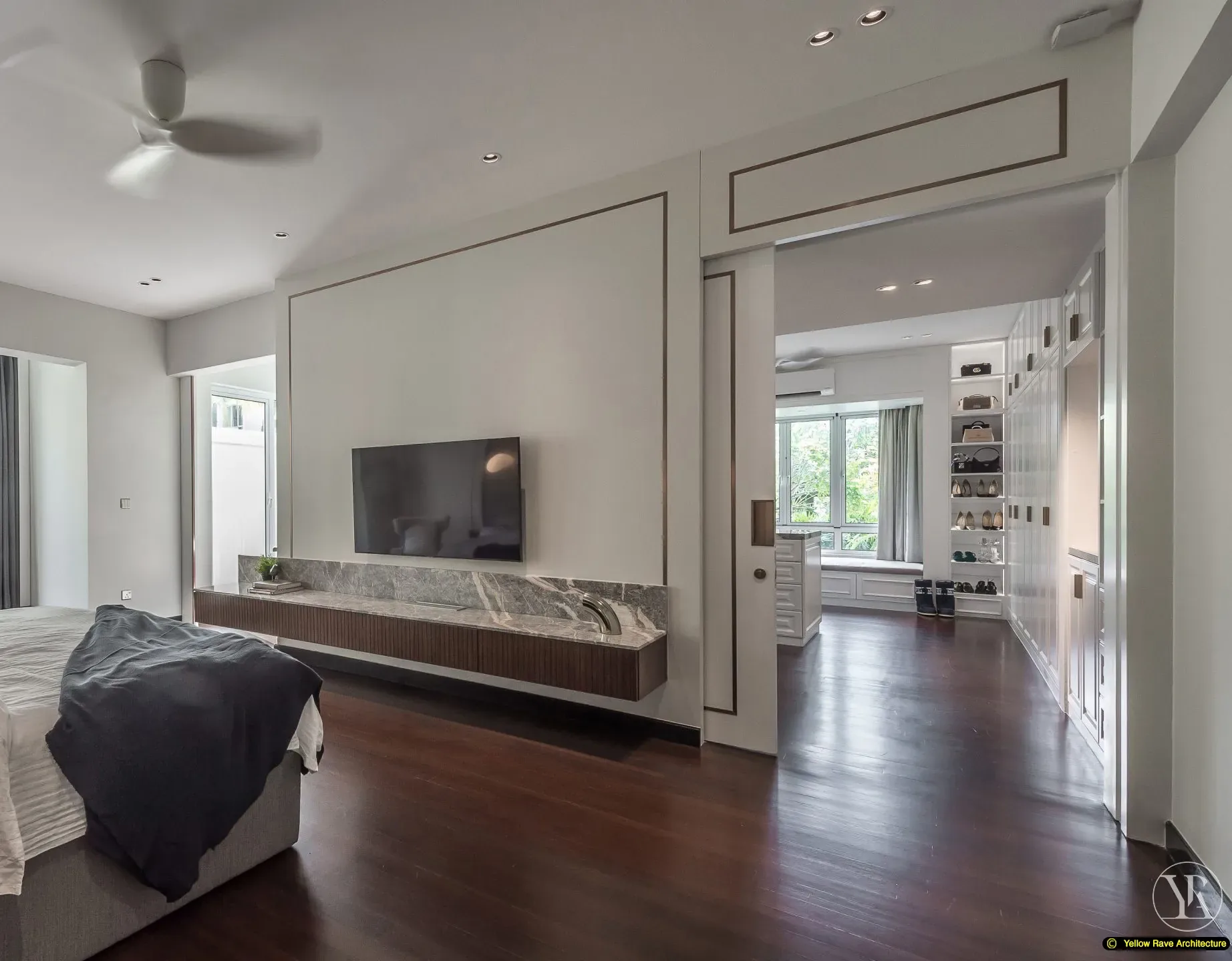 Pristine Walk-in Closet — master bedroom showing grey upholstered headboard with dark timber batten surround, full-height grey marble headboard wall and two brass globe pendant lights