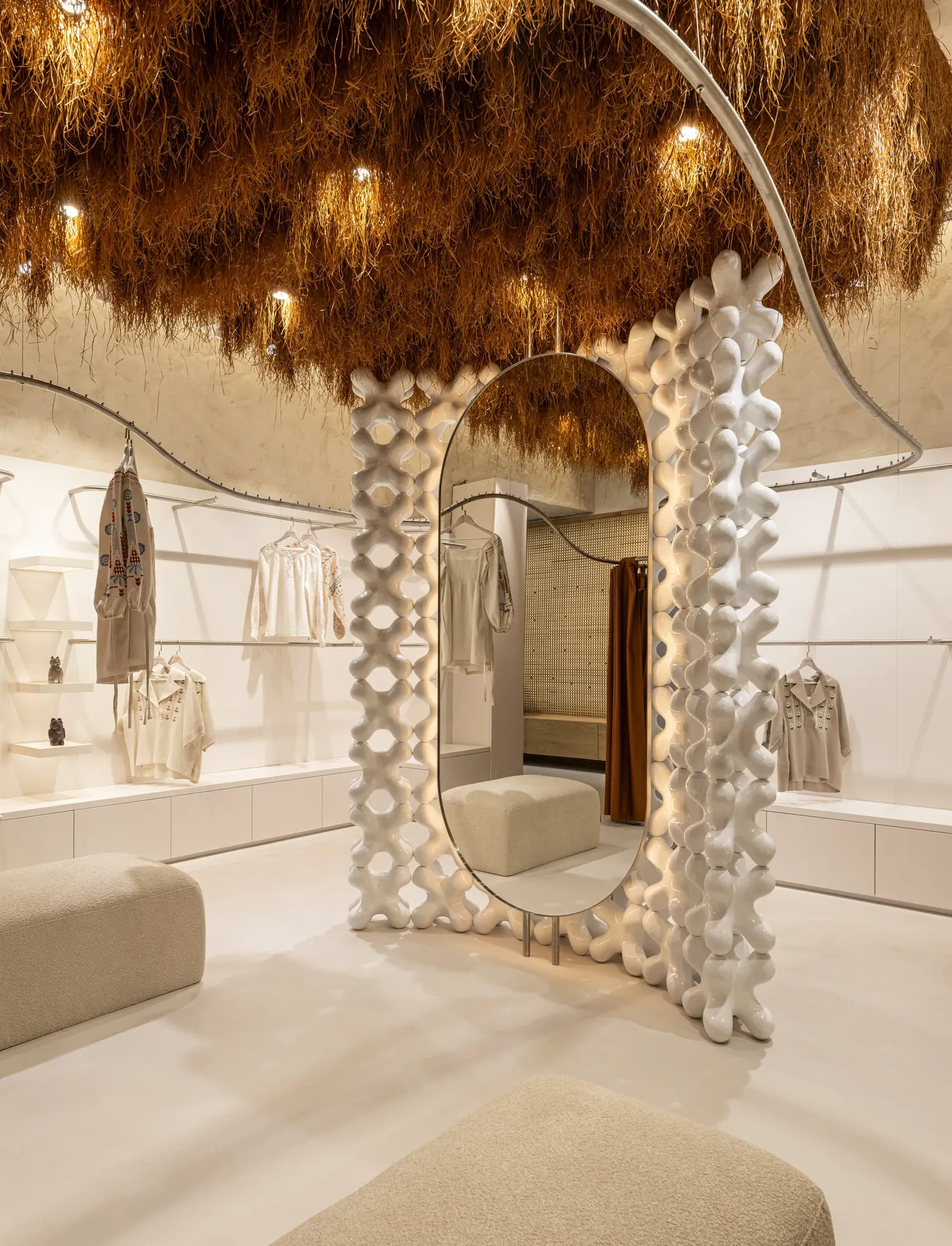 Miko Heritage Boutique — fitting area with sculptural ceramic lattice mirror frame and suspended straw ceiling