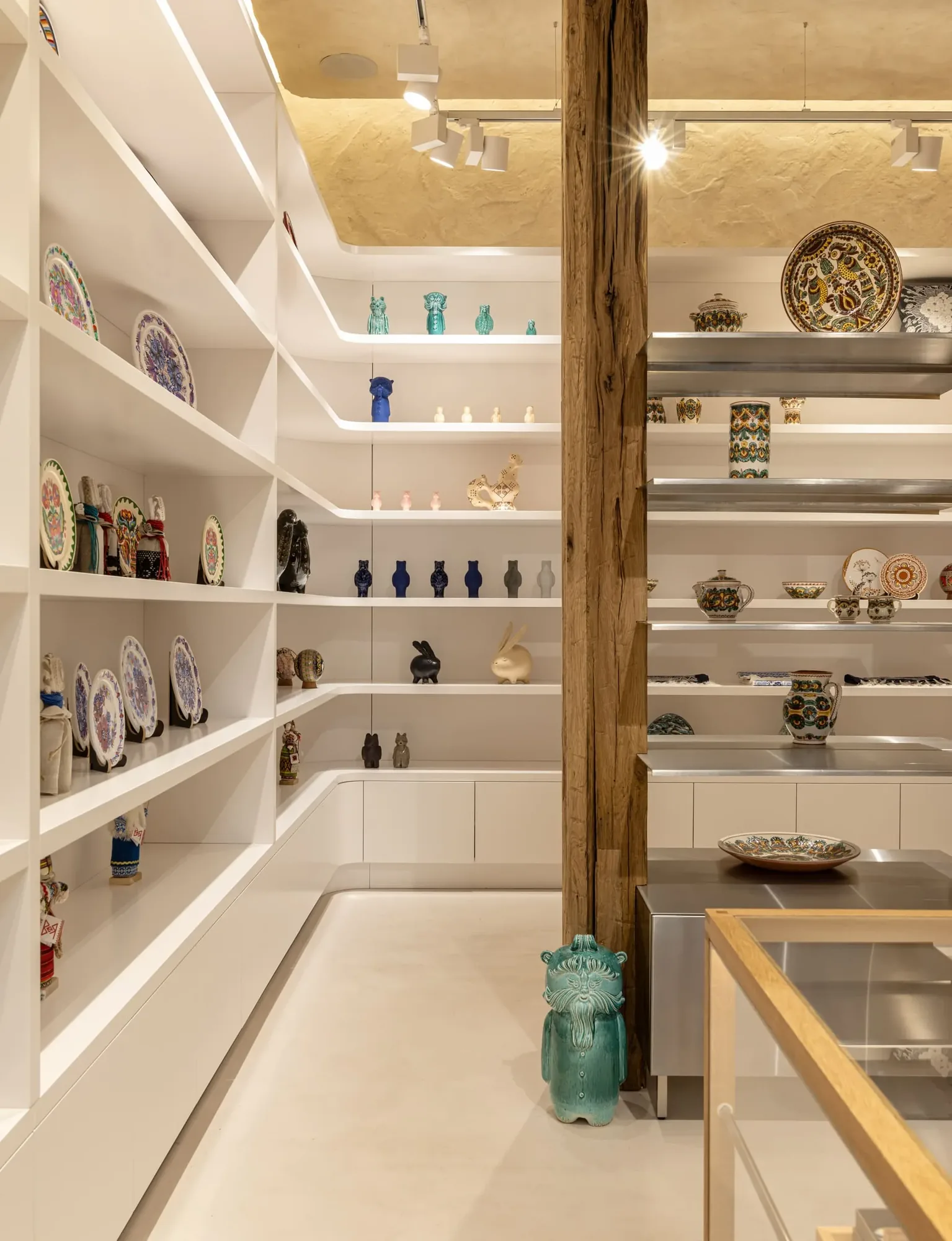 Miko Heritage Boutique — glass display cases with ceramic artefacts on lime-rendered walls