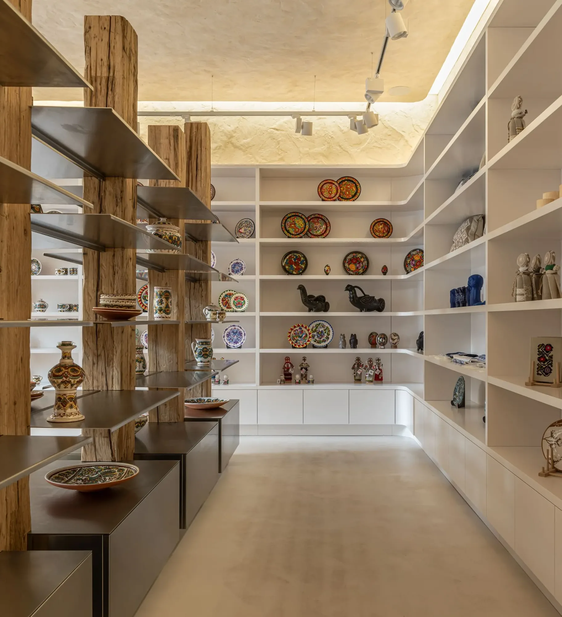 Miko Heritage Boutique — full-room view showing the tension between raw and refined materials throughout