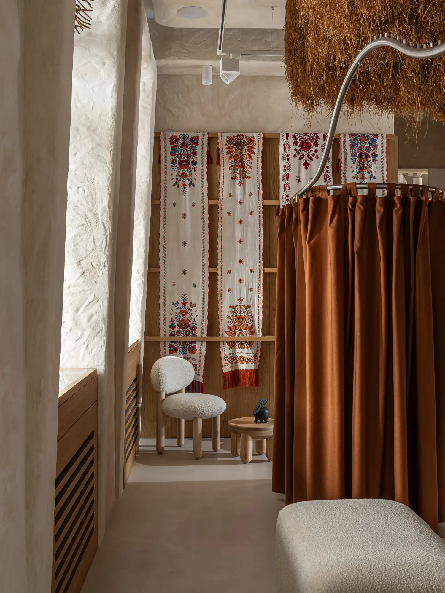 Miko Heritage Boutique — side view of glass artefact cases with lighting and straw ceiling beyond