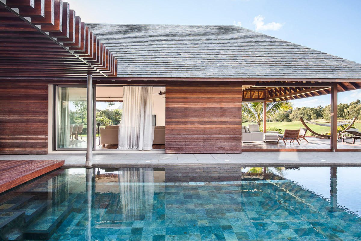 Serenity Abode — lap pool connecting the two pavilions with tropical landscape beyond