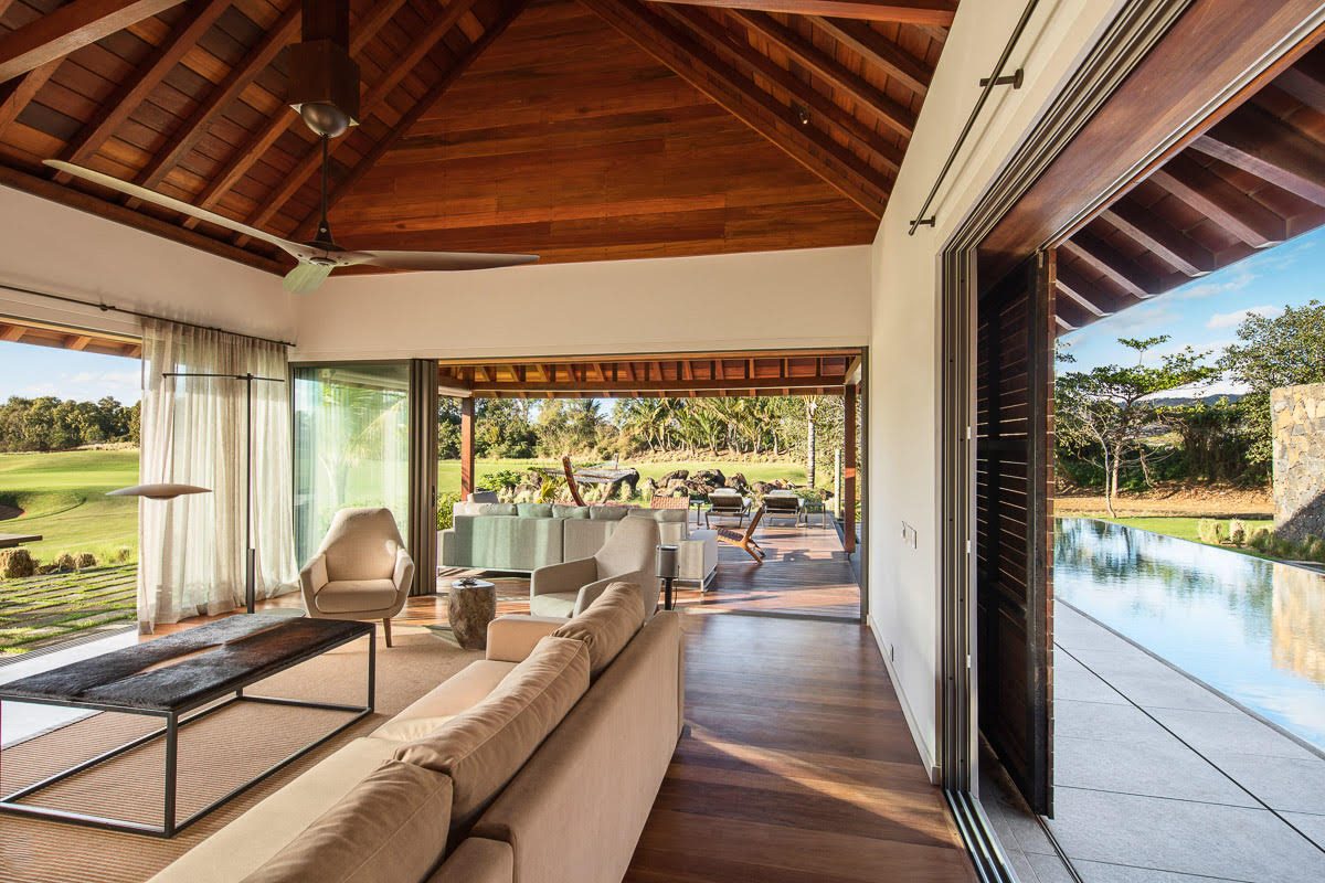 Serenity Abode — covered outdoor terrace with exposed timber roof structure overlooking the pool and landscape