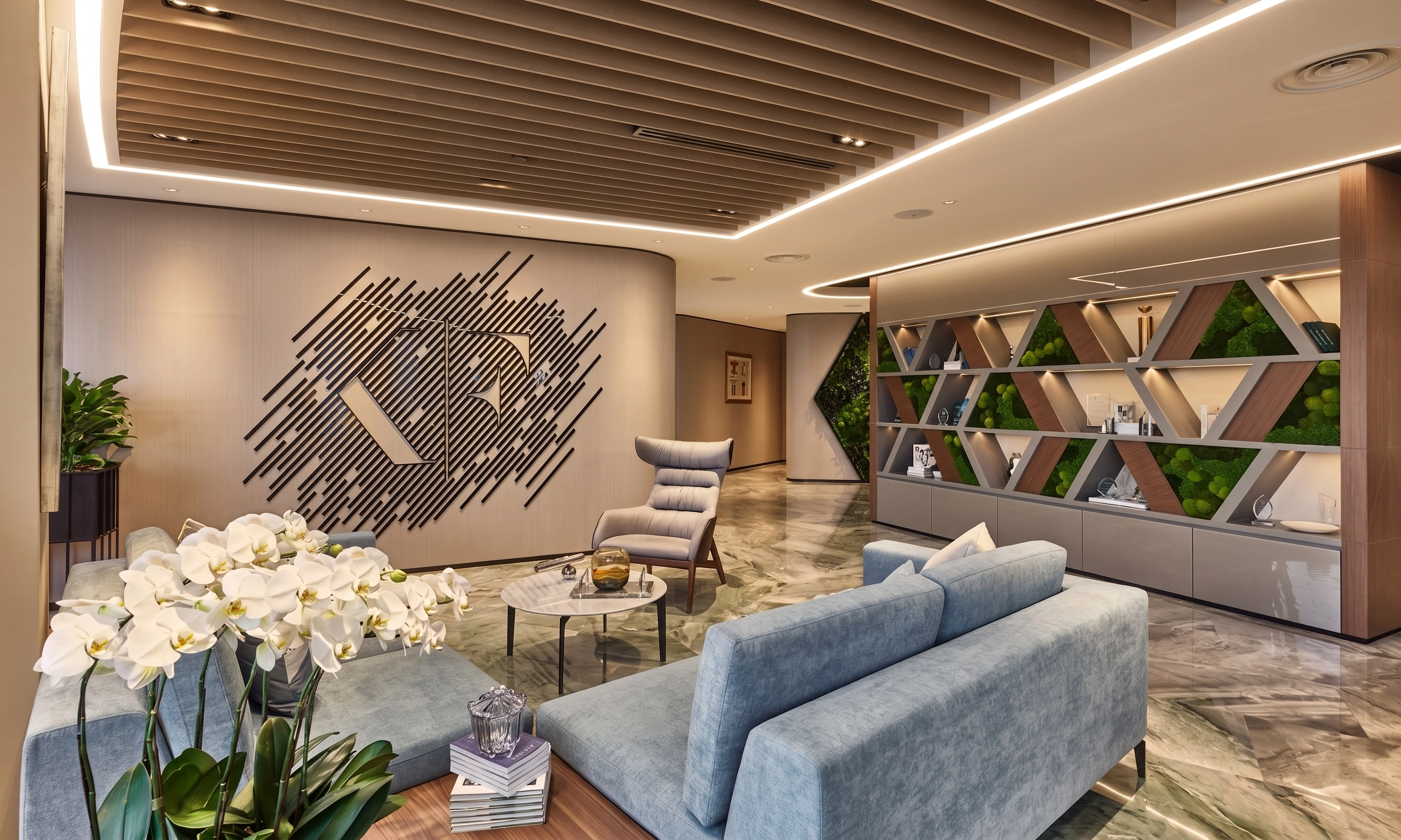 Office lounge with blue sofas, a diamond-pattern display shelf with greenery, and a slatted timber ceiling
